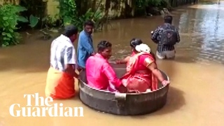 Indian couple float to wedding in cooking pot after floods in Kerala
